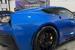 A sleek blue Corvette sports car showcasing its stylish rear end, highlighting its sporty design and curves.